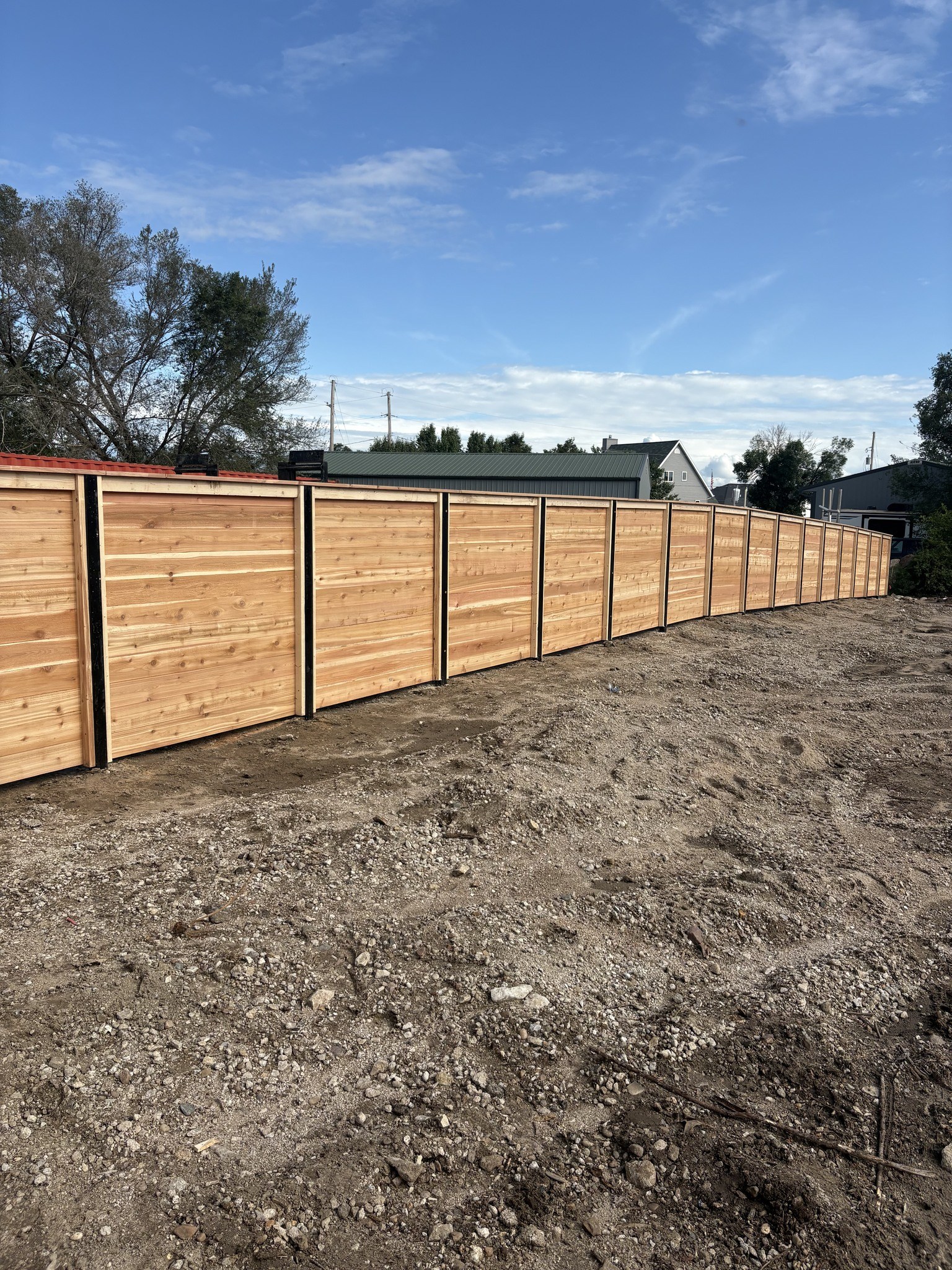 Custom wooden fence installation with black posts by TaylorMade Fence LLC in Omaha Nebraska